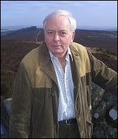 Colour portrait of W. G. Runciman with a green hilly background.